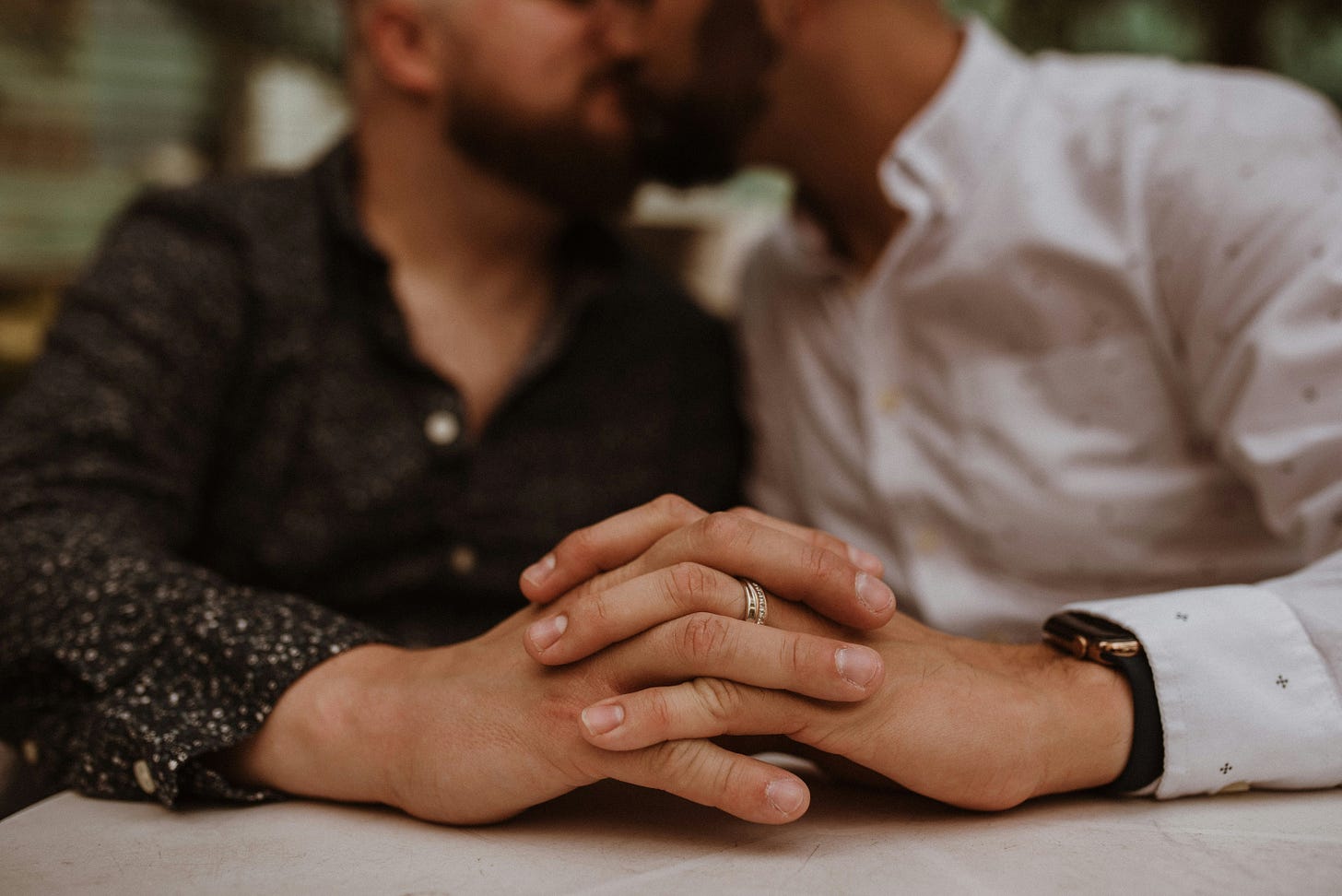 gay couple holding hands showing intimacy