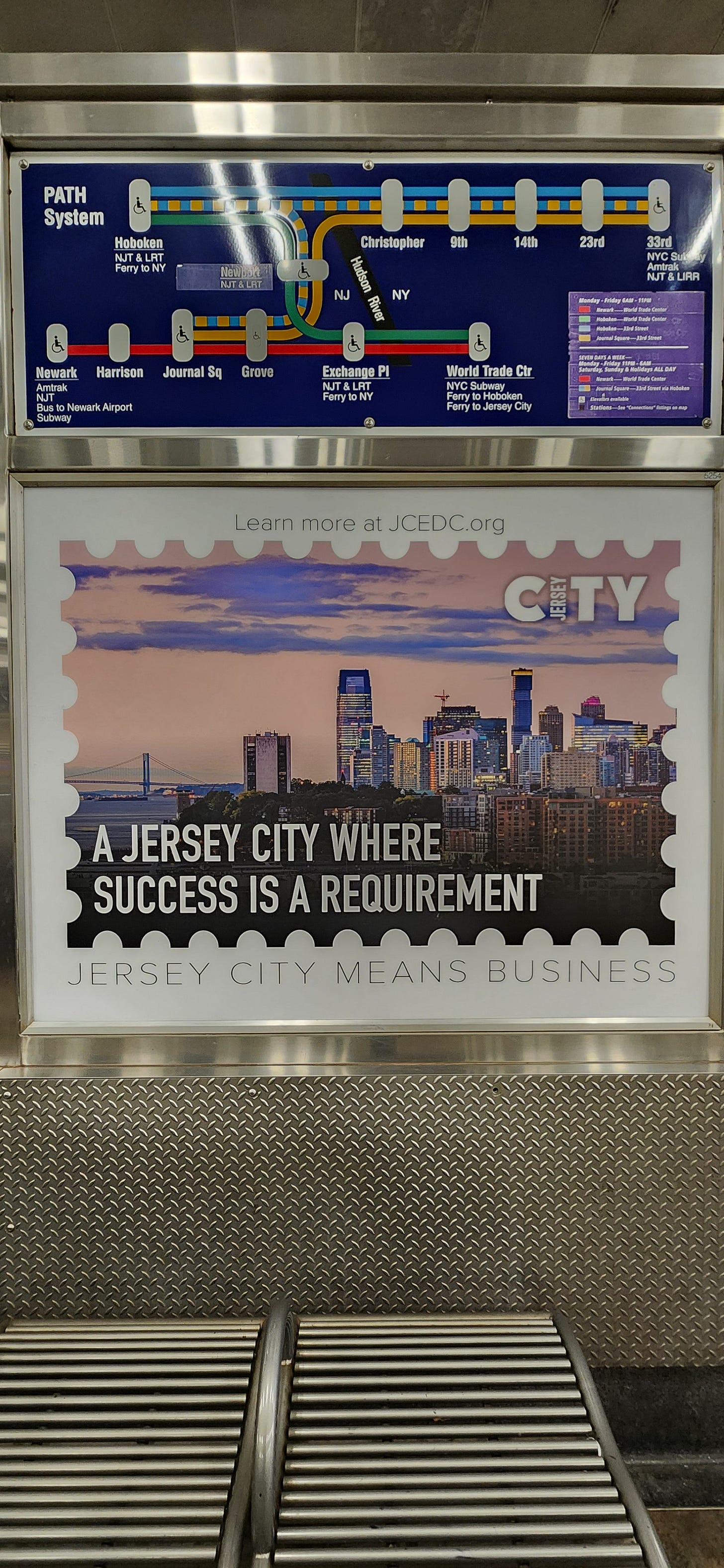Below, a map of the PATH train's route, an ad features a picture of the Jersey City (aka Chilltown) waterfront with “A JERSEY CITY WHERE SUCCESS IS A REQUIREMENT” in the bottom left of the image; just below the frame of that image are the words: JERSEY CITY MEANS BUSINESS. 