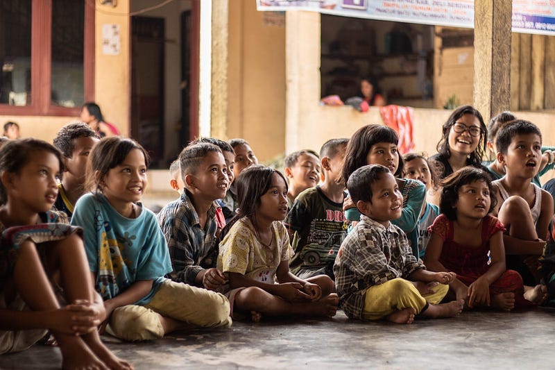 A group of children being taught in classroom