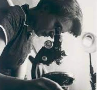 image of a women looking into a microscope