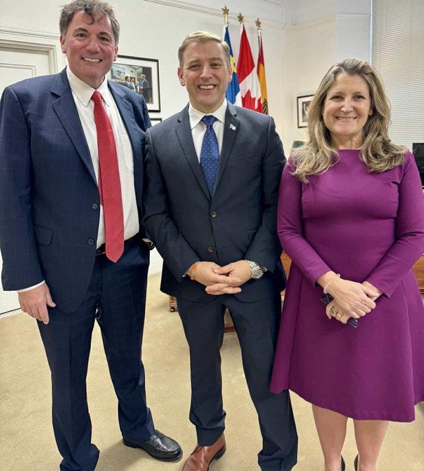 LeBlanc, Premier and Freeland stand together.