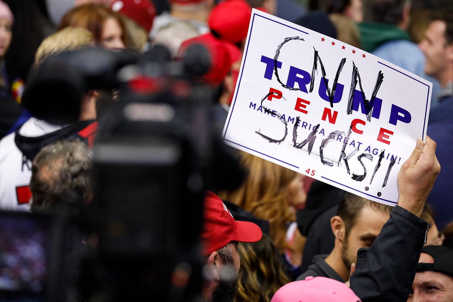 A Trump supporter holds a sign reading “CNN sucks” in 2018 in Fort Wayne, Indiana. (Photo by Aaron P. Bernstein/Getty Images)