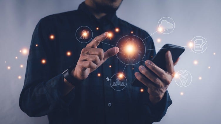 Man creating sparkles throughout photo by tapping the screen on his cell phone.