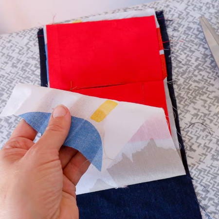 folding a fabric piece over to construct a welt pocket