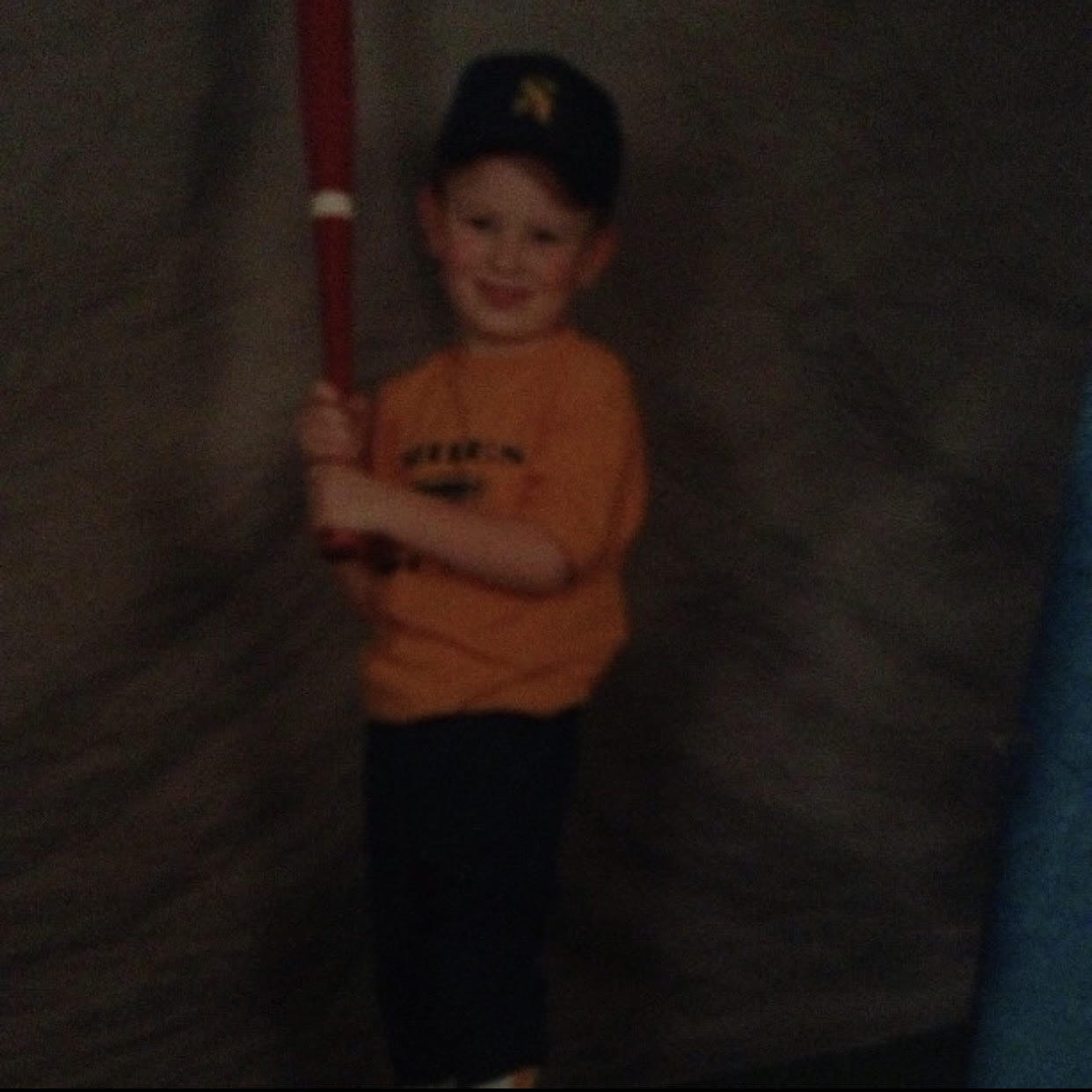 A picture from 2003 showing me, Justice, as a six-year-old holding a baseball bat.