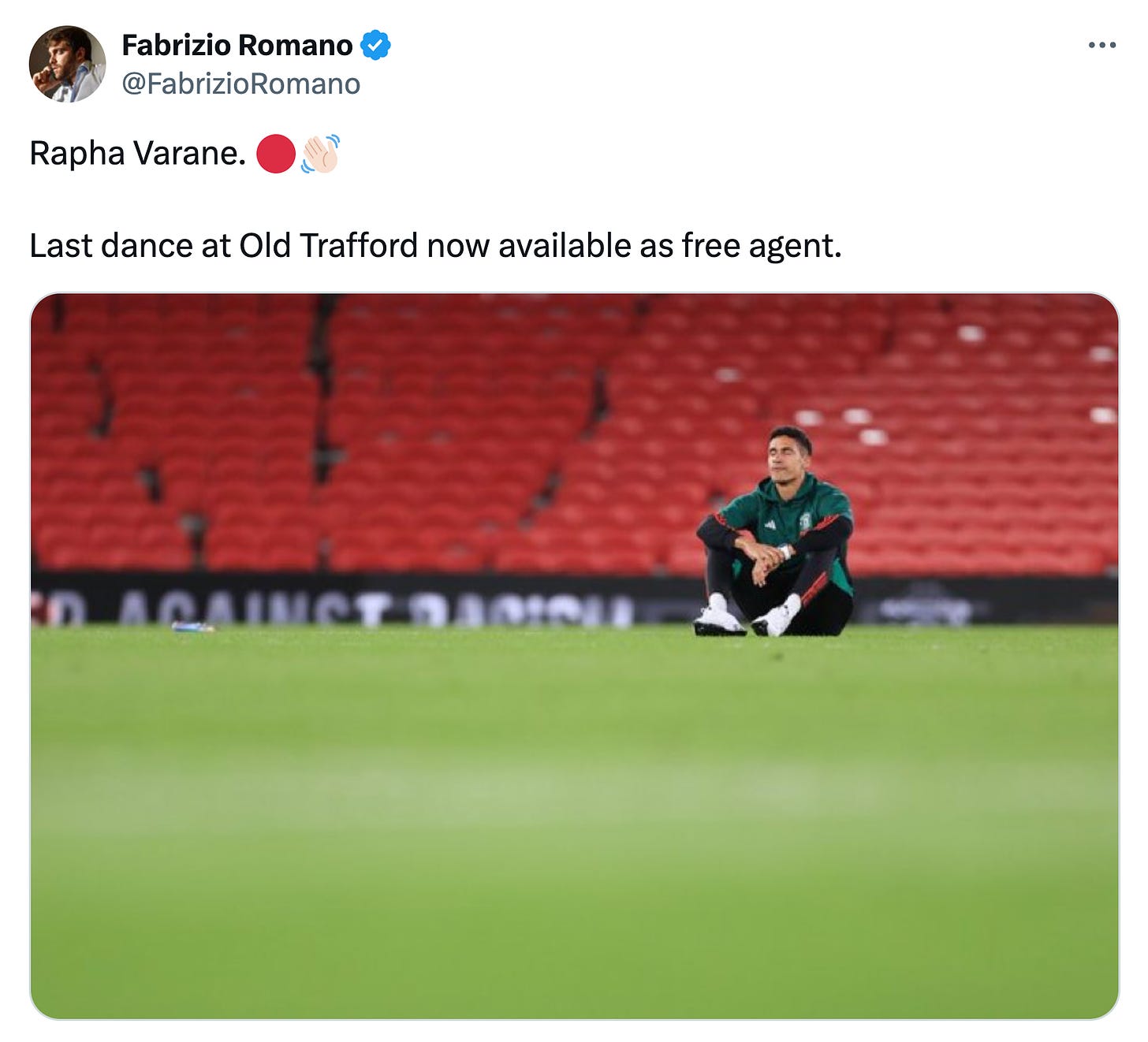 A tweet by Fabrizio Romano showing Raphael Varane sitting on the field at Old Trafford