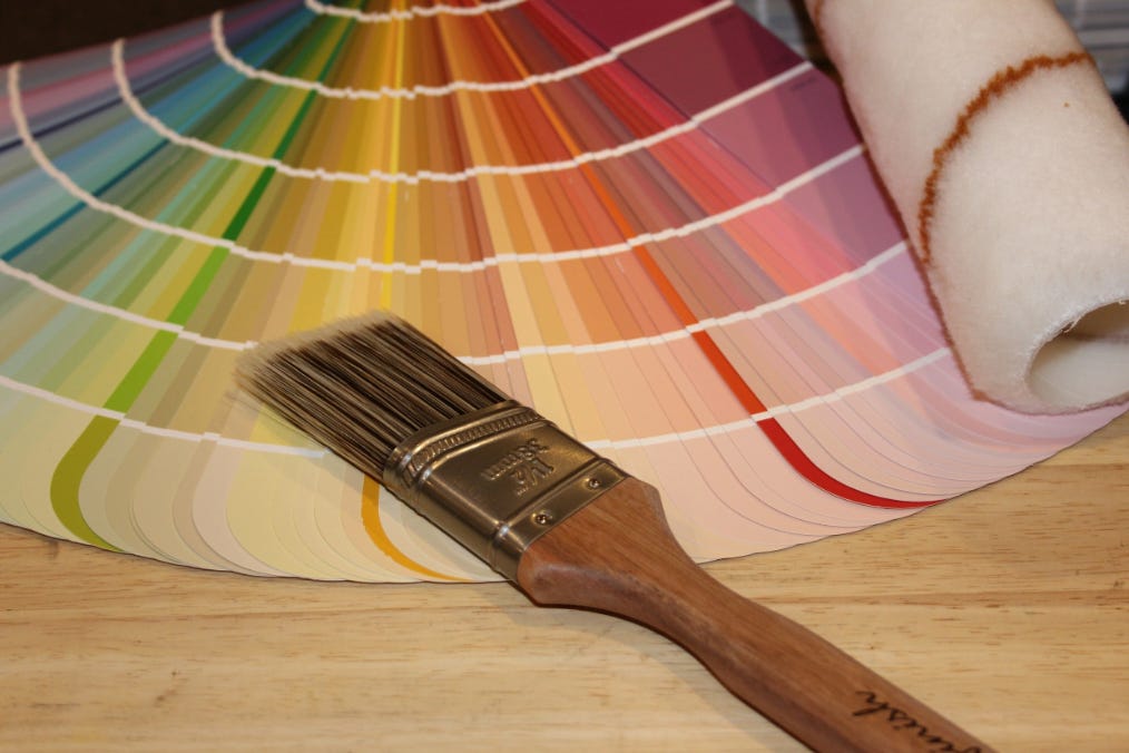 Fan of paint color samples and paint brush