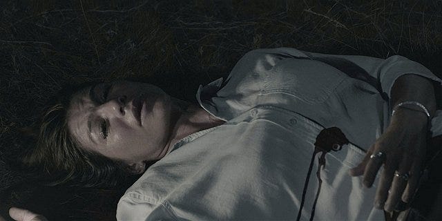 Walker Emily dead wife body shot in grass.