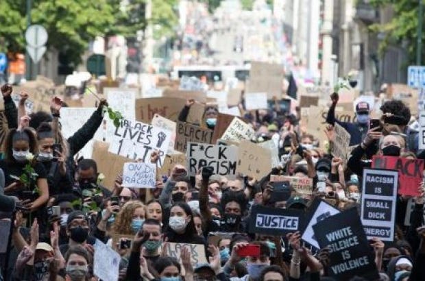 Protestors march down the streets with signs saying 'Black lives matter'