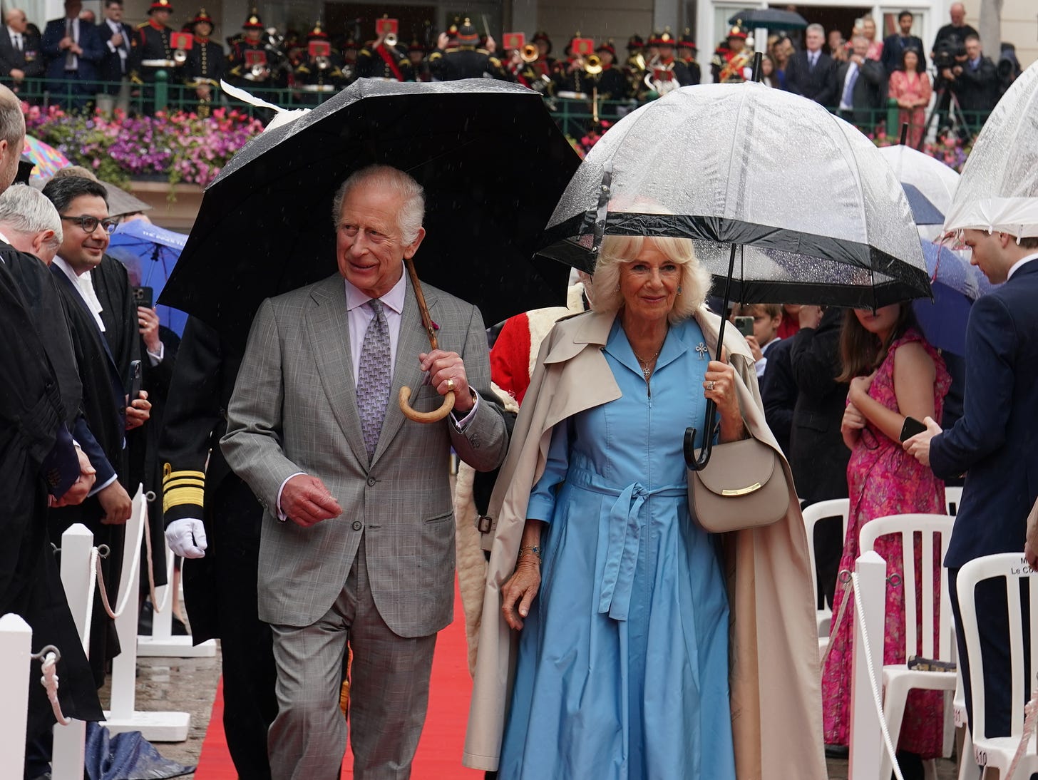 Charles and Camilla greet crowds in the rain in Jersey