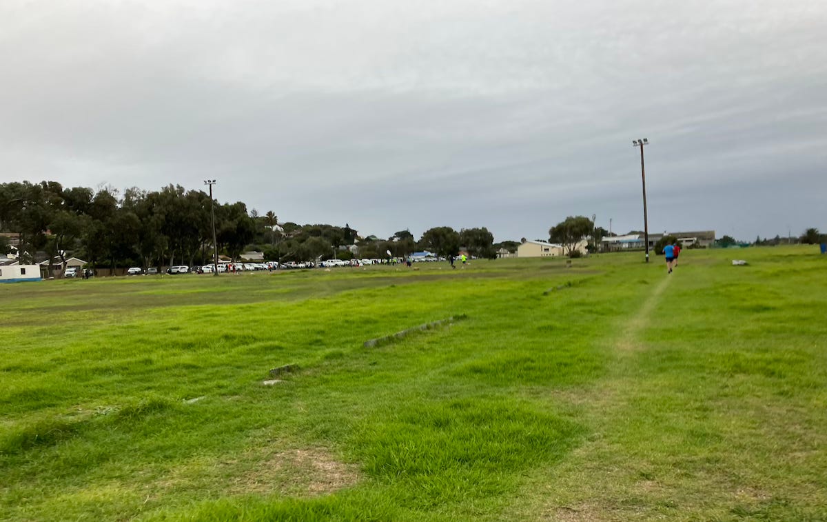 A large field with a worn path along one side