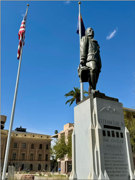 A statue of a person holding a flag

Description automatically generated