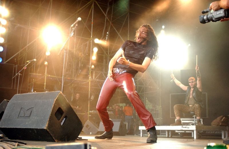 Air on Maiden - an air guitar band performing at a large festival stage