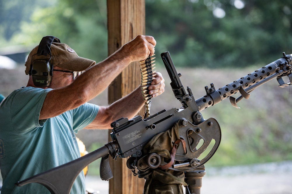 A man loads bullets into a machine gun during the Hillsborough County Republican Committee Sixth Annual Full-Auto Machine Gun Shoot in Litchfield, New Hampshire, on July 27, 2024. 