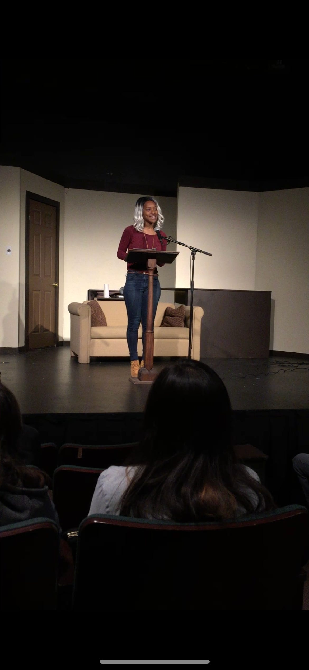 Kat Lewis performing in a small college theater.