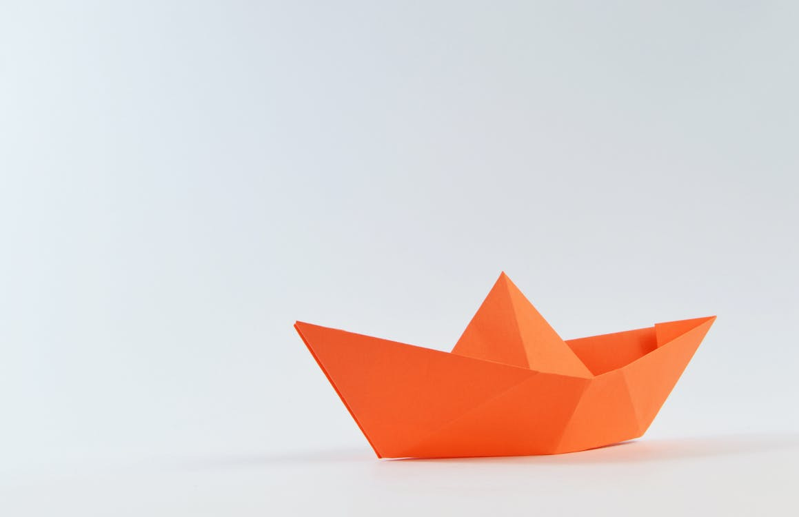 Free Orange Paper Boat on White Surface Stock Photo