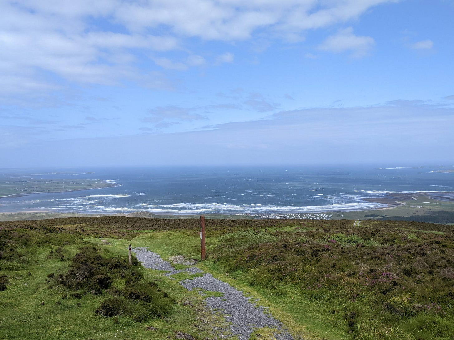 A vista from a hill out into the north Atlantic, which foams in the background