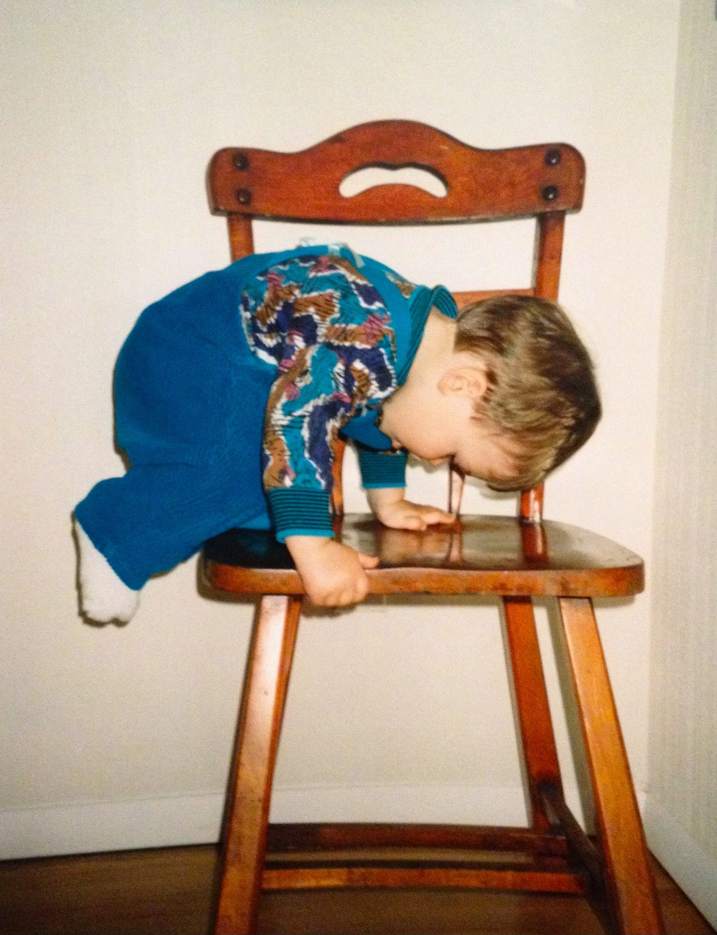 Toddler climbing onto a chair