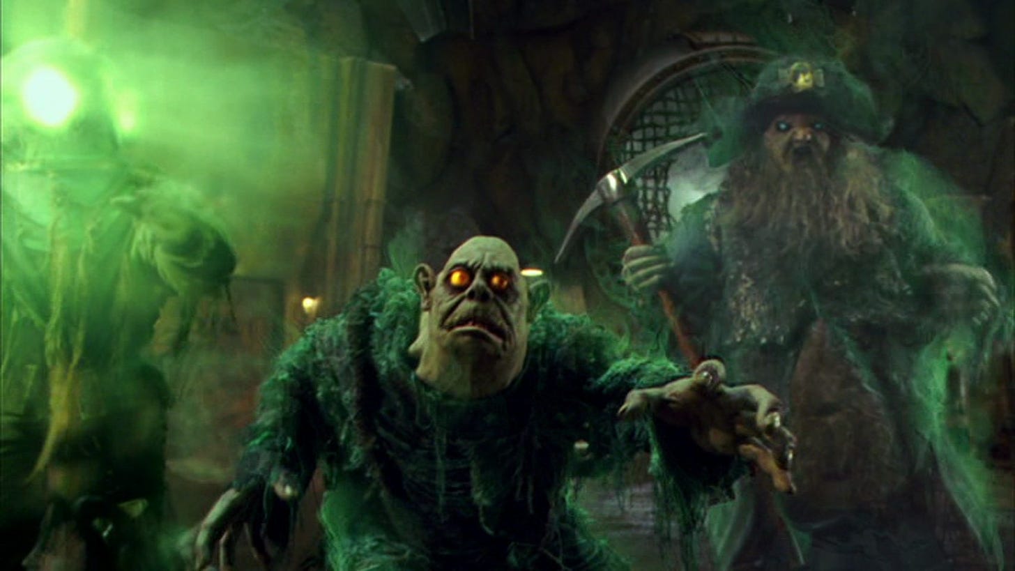 Movie still from Scooby-Doo 2: Monsters Unleashed. A group of spooky, goofy green monsters approach.