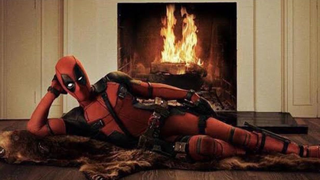 deadpool in front of hot fireplace burning