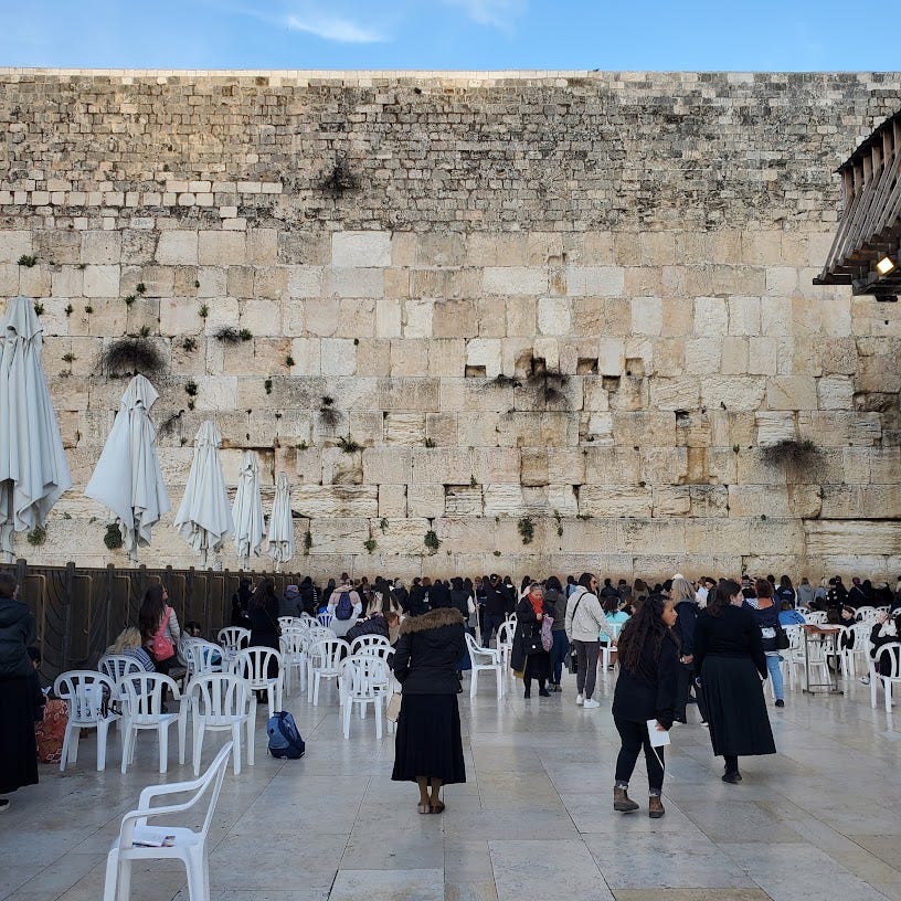 Women gather in the women's section of the Kotel. 