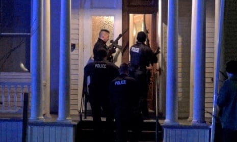 Police search a house after a gunman shot three Palestinian college students in Burlington, Vermont on Saturday.