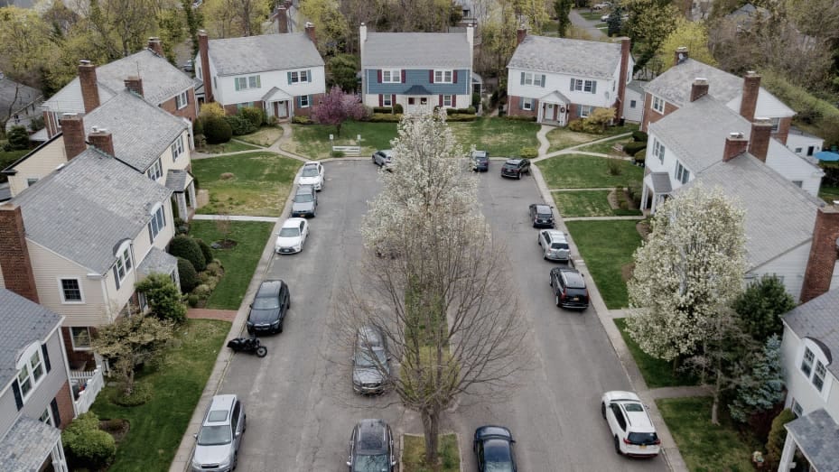 Vehicles parked outside residential homes in Manhasset, New York, U.S., on Friday, April 16, 2021. Across the U.S., house hunters are fighting for scraps in a market picked clean of listings during the key spring homebuying season. Photographer: Johnny Milano/Bloomberg via Getty Images