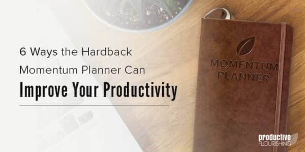 The Momentum Planner on a wooden desk. Text overlay: 6 Ways the Hardback Momentum Planner Can Improve Your Productivity