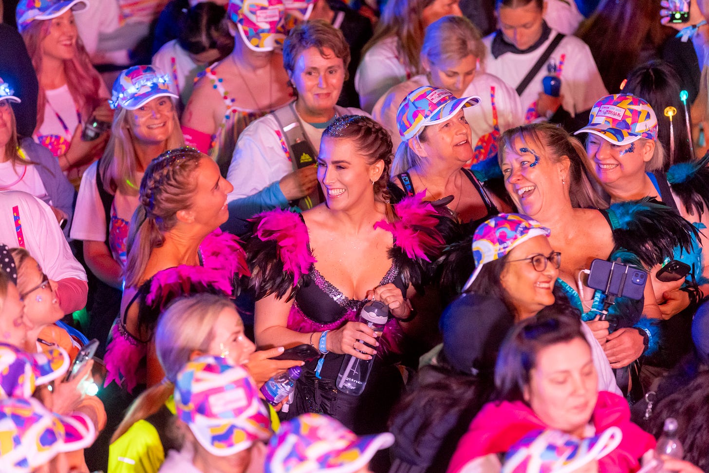 Crowd of women dressed in decorated bras for charity event