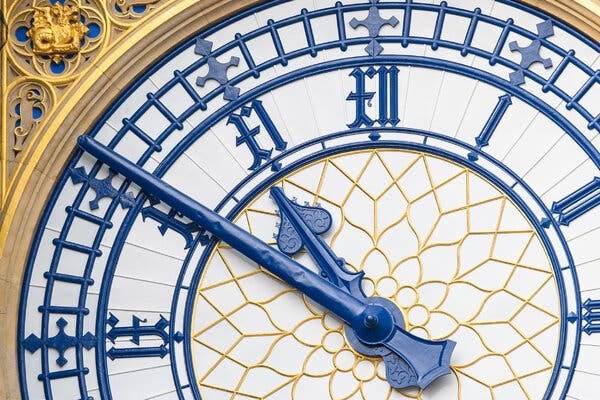 The giant, ornate clock hands of Big Ben.