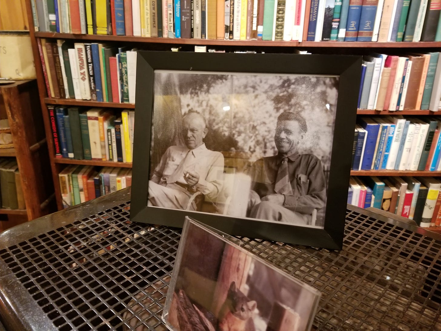 framed photo of leopold and murie on table with bookshelf in background