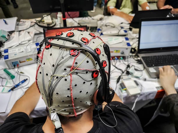 Brain computer interface lab equipments The electroencephalogram (EEG) head cap with flat metal discs (electrodes) in a science lab with laptops blurred at the background Brain-Computer Interfaces stock pictures, royalty-free photos & images