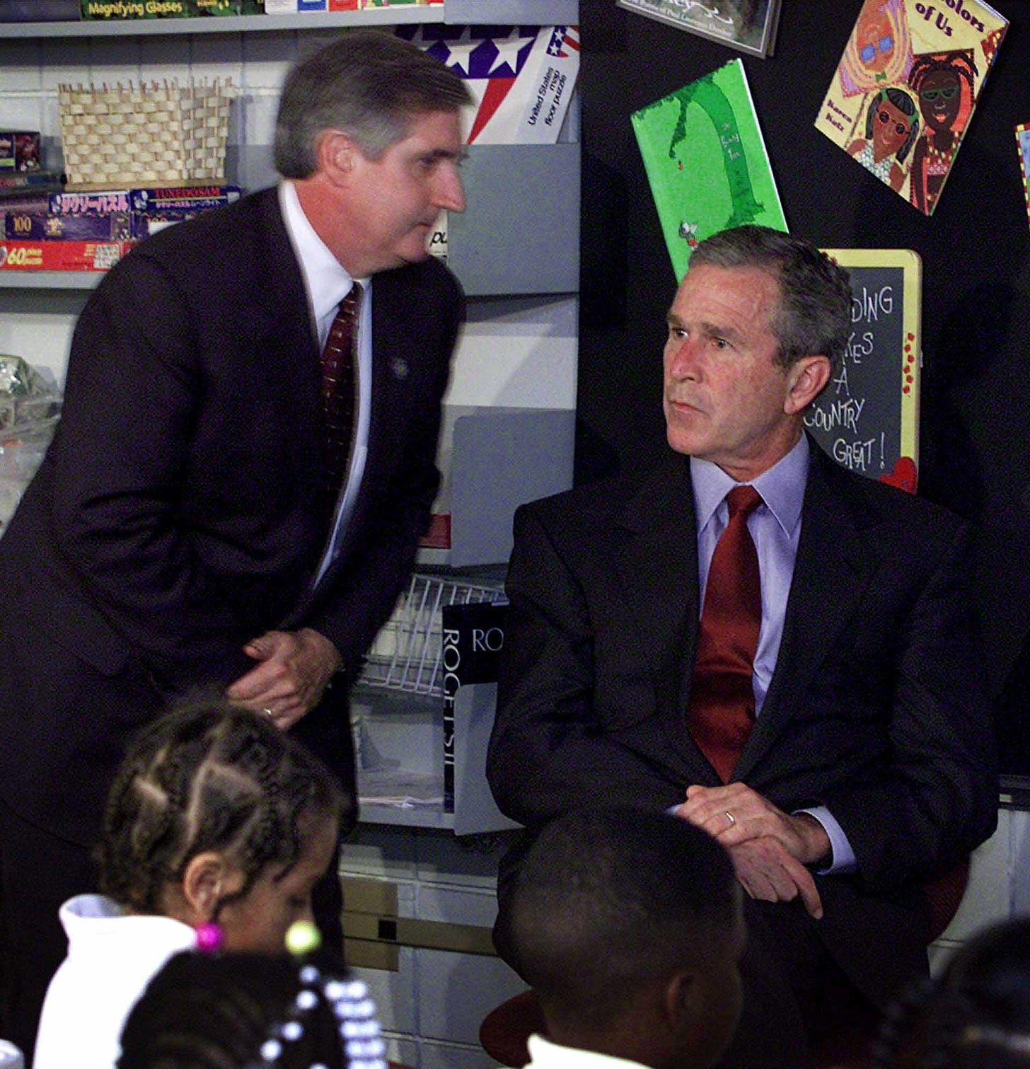 Andrew Card informing George W. Bush on 9-11 that a second airplane has struck the World Trade Center