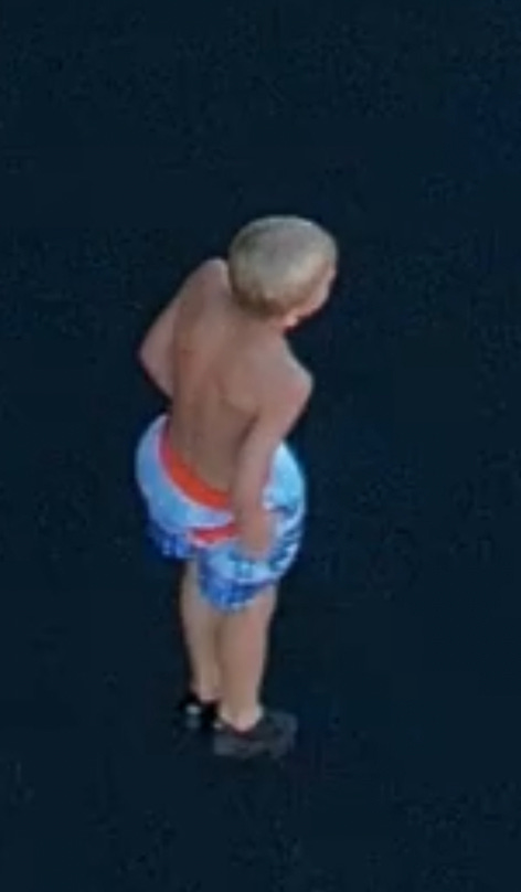 A child in shorts and a shirtless top

Description automatically generated