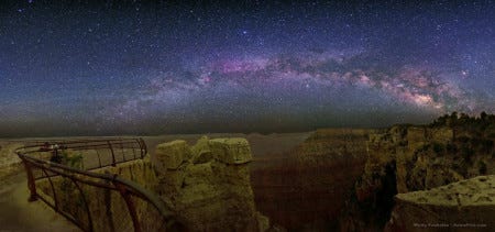 a panorama of the night sky over a desolate desert