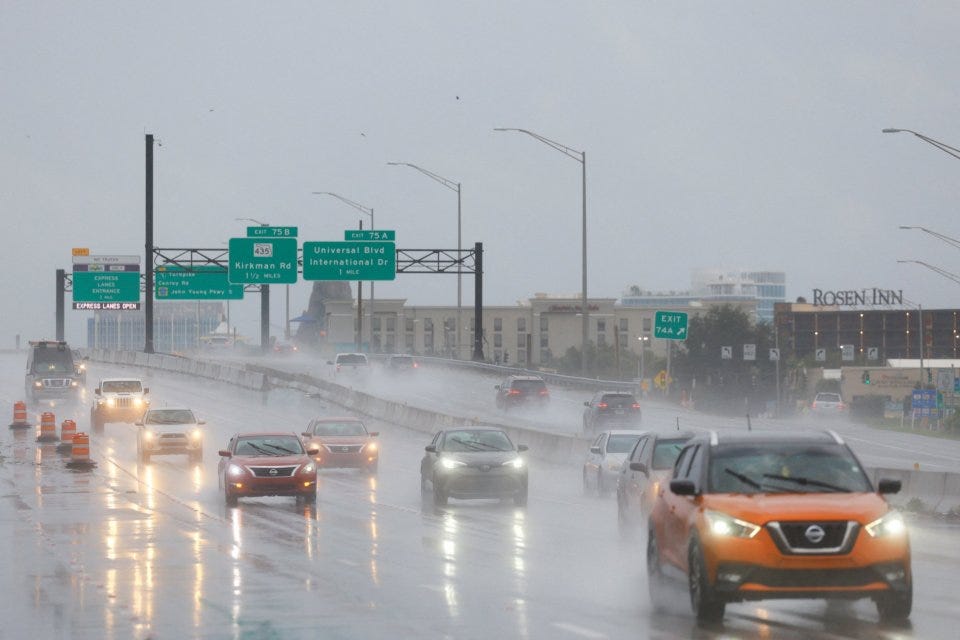 Cars drive during heavy rainfall as Hurricane Milton nears landfall in Orlando