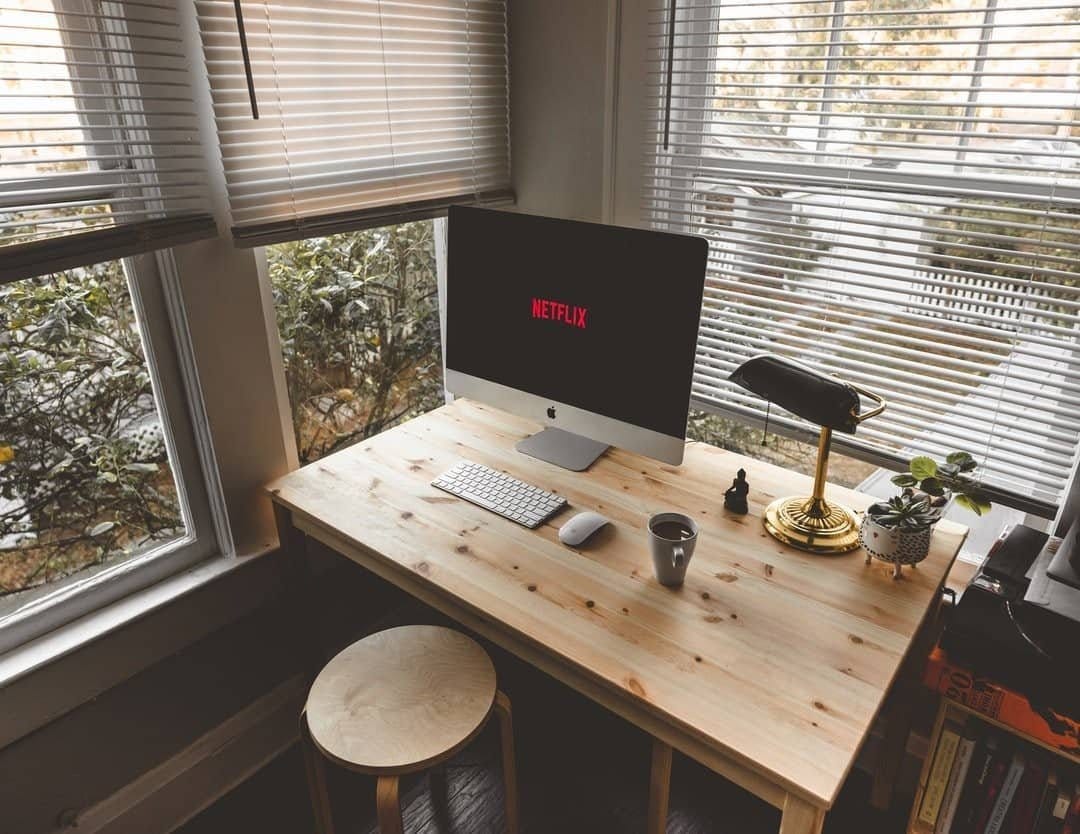 image of work area with the iMac and netflix on