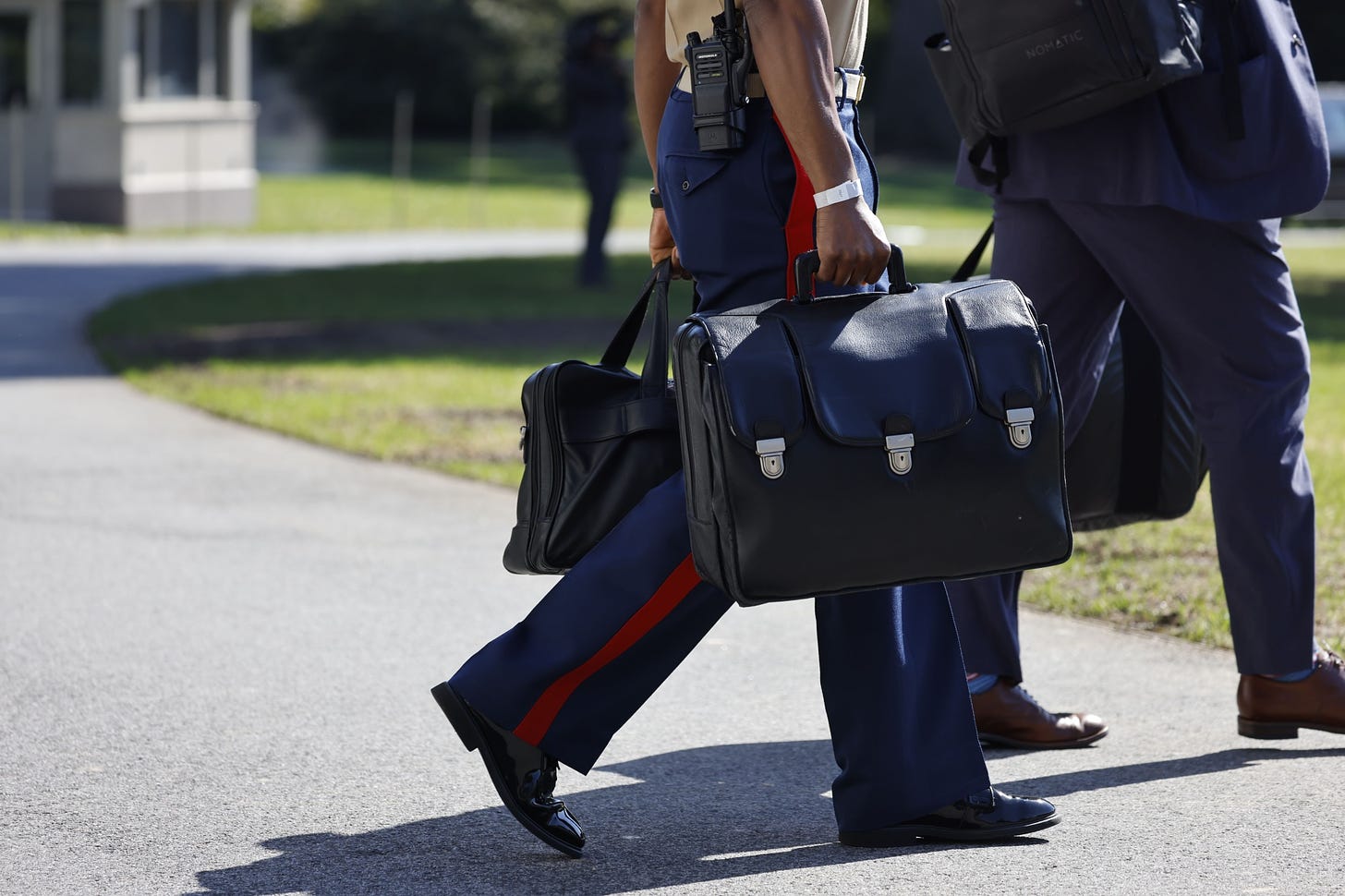 A military aide carries the &quot;nuclear football,&quot; which contains launch codes for nuclear weapons, as he follows US President Joe Biden, not pictured, onto Marine One on the South Lawn of the White House Washington, DC on Friday, Oct. 7, 2022.&nbsp;