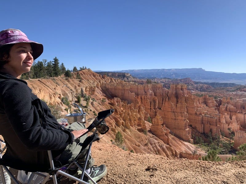 Rey sitting in a camp chair, overlooking the rim of Bryce Canyon