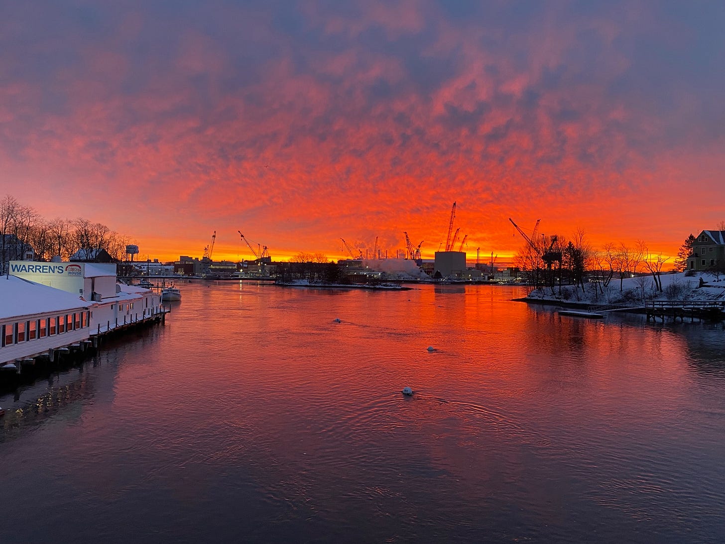 Bright orange horizon, over the water. Kittery at sunrise, looking toward Portsmouth Naval Shipyard.