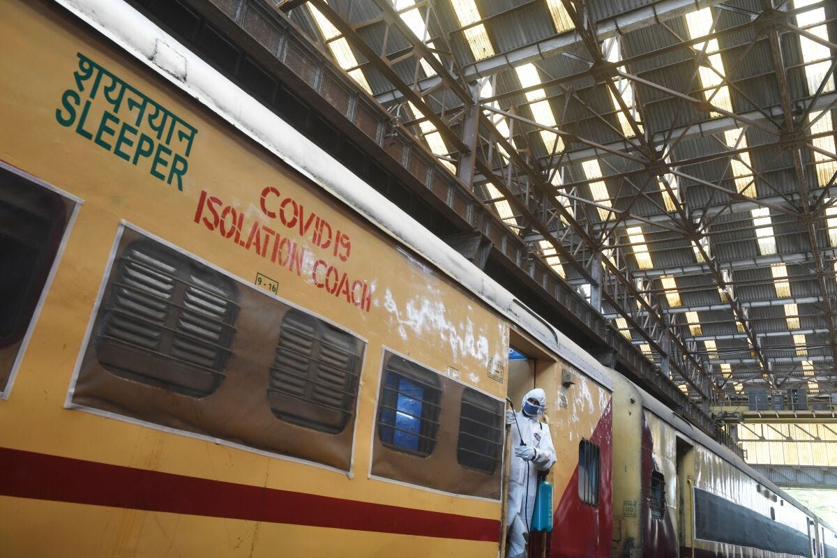 A worker sprays disinfectant on a train carriage converted into an isolation ward for COVID-19 patients near Kolkata, India, on Sunday.