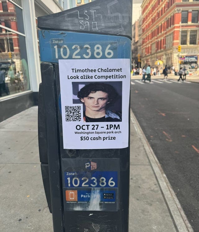 Timothee Chalamet walking past the Timothee Chalamet look alike contest  poster while filming Marty Supreme in New York : r/Fauxmoi