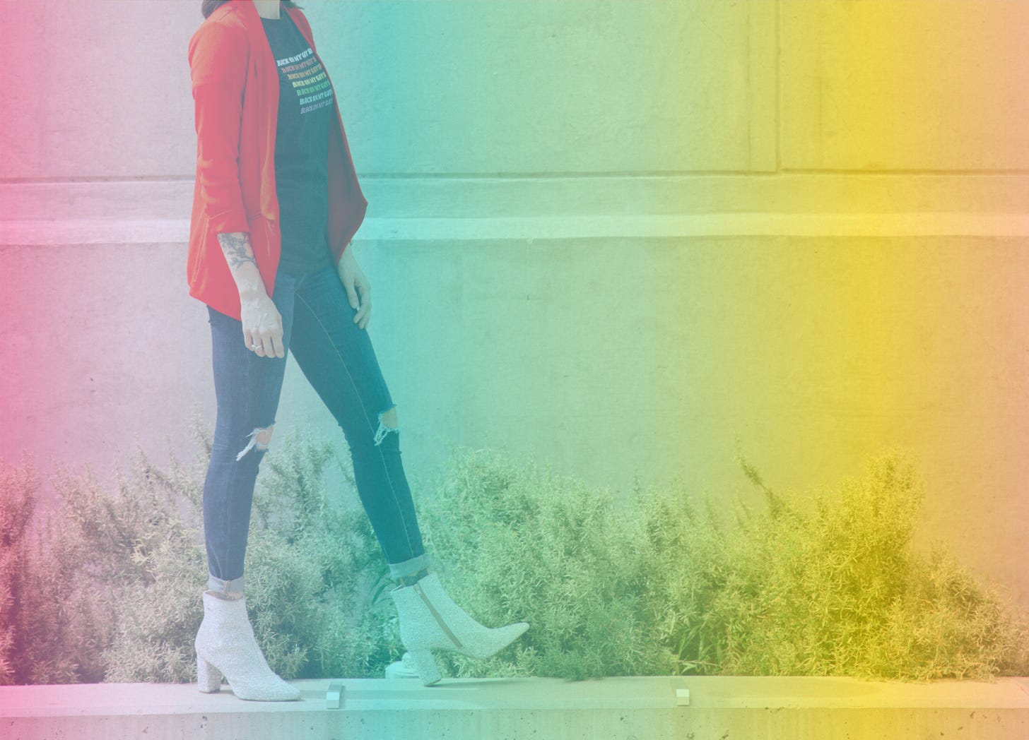 A rainbow-filtered photograph of Shohreh's bed cut at the neck walking along a ledge in a glittery disco boots