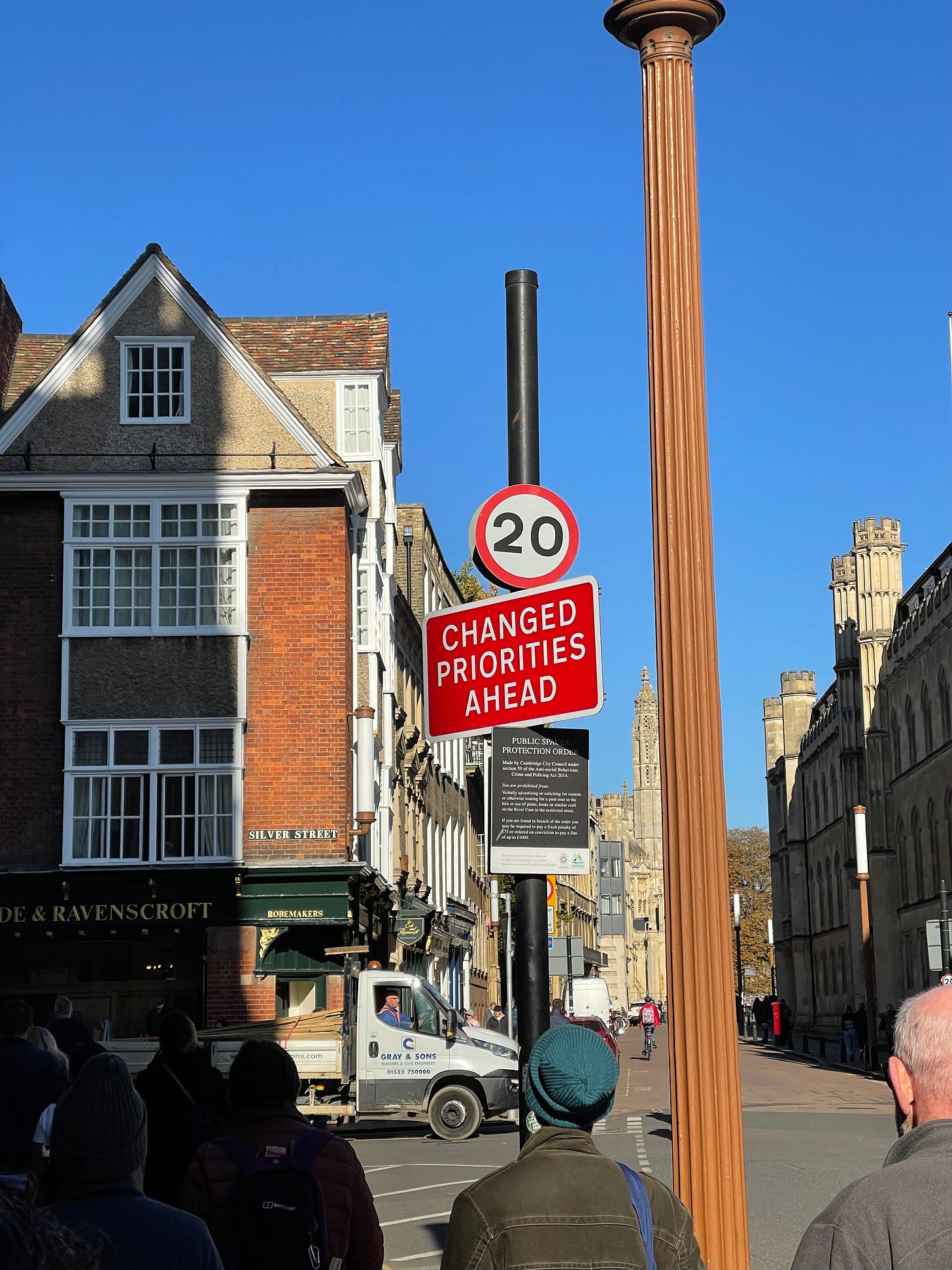 Street sign in the UK that reads "Changed Priorities Ahead"