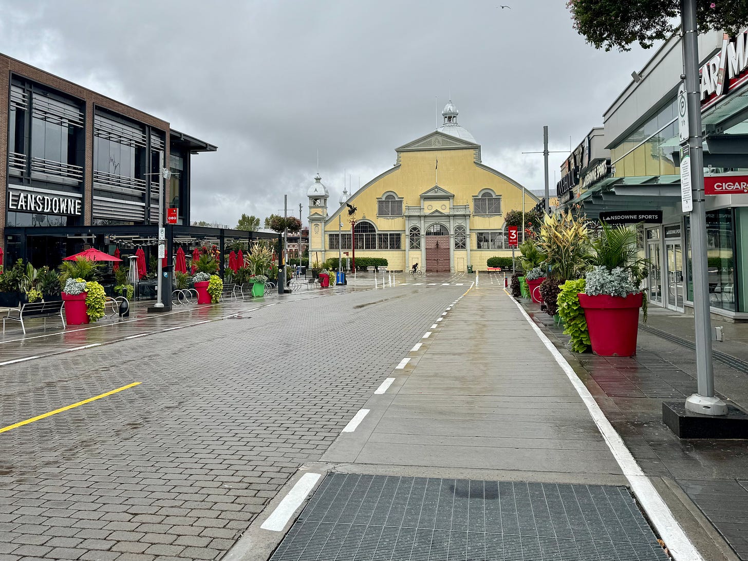 A view of Market Way at Lansdowne Park in Ottawa. It is a wet and overcast day, and there are no people present.