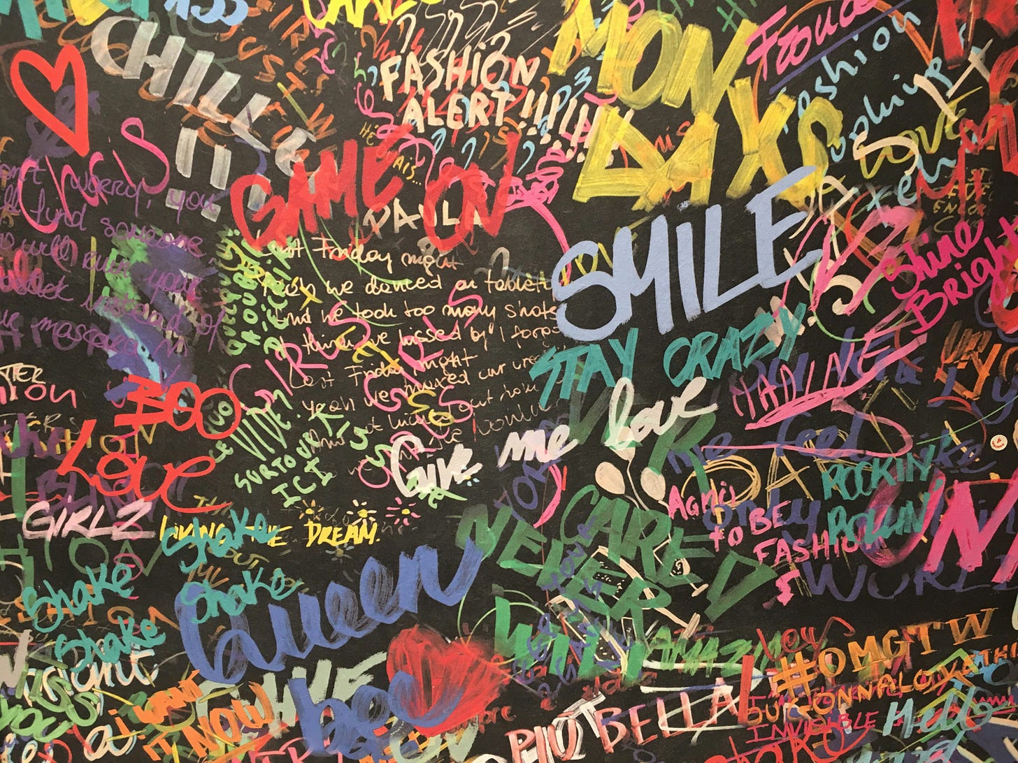 colorful words on a graffiti wall