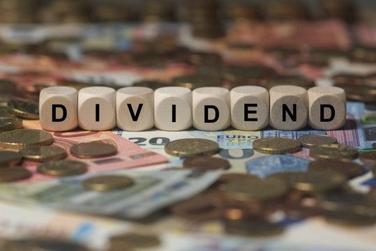 dividend - cube with letters, money sector terms - sign with wooden cubes  Stock Photo | Adobe Stock