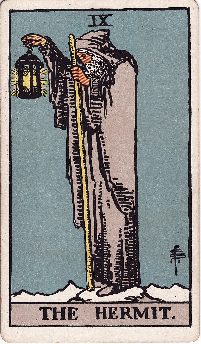 The Hermit tarot card. An old man with a white beard and cape carries a walking stick and a black lantern with a 6 pointed star lighting his way. The background is blue with a roman numeral nine (IX) at the top. 