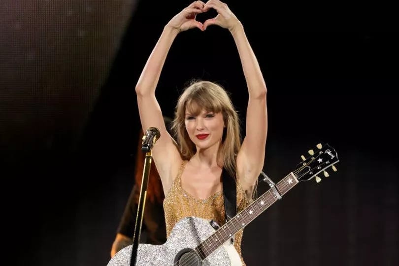 Taylor Swift making a heart with her hands