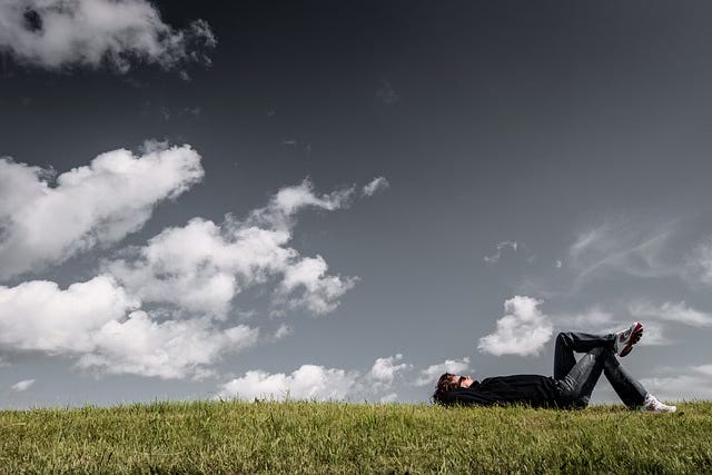 thinking person laying on ground